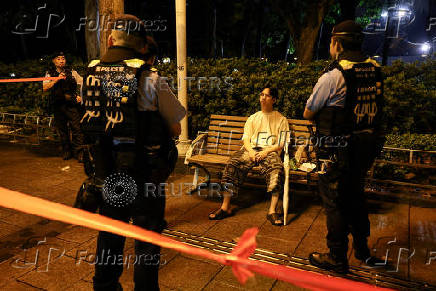 Police surround man at Victoria Park during Tiananmen Square crackdown anniversary in Hong Kong