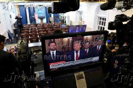 Member of the media report from the White House in Washington