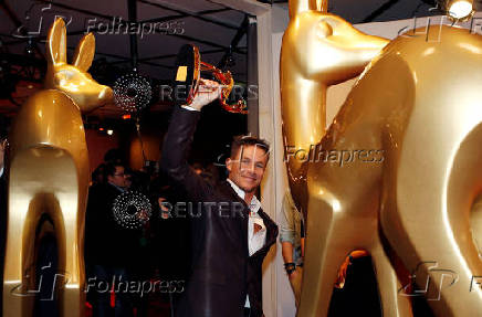 FILE PHOTO: Austrian space jumper Baumgartner poses with his trophy after the 64th Bambi media awards ceremony in Duesseldorf