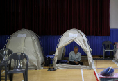 People evacuated from villages, damaged by torrential rain, rest at a temporary shelter, in Yesan,