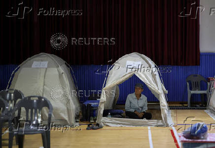 People evacuated from villages, damaged by torrential rain, rest at a temporary shelter, in Yesan,