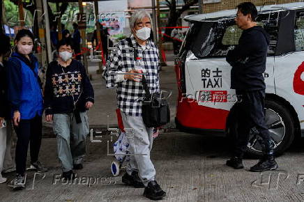 Hong Kong residents affected by the fire gather their belongings from their apartments