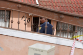 Police officers inspect the scene where kidnapped U.S. pastor, Josh Sullivan, was rescued last night in a shootout during which three suspects were killed, in KwaMagxaki