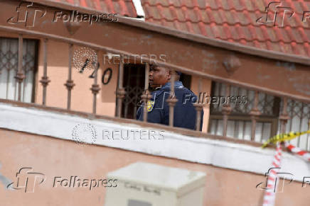 Police officers inspect the scene where kidnapped U.S. pastor, Josh Sullivan, was rescued last night in a shootout during which three suspects were killed, in KwaMagxaki