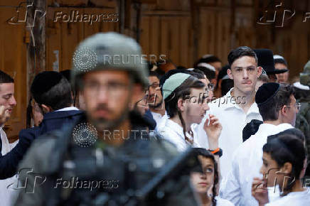 Israeli troops stand guard during a weekly settlers' tour in Hebron