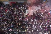 Players of Bologna FC and fans celebrate in Bologna