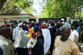 Mourners wait to gain access into former president Buhari's residence ahead of his burial