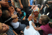 Mourners react during the funeral of Palestinians killed in overnight Israeli strikes, according to medics, at Al-Shifa hospital in Gaza City