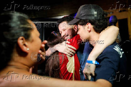 Arturo Suarez, who was held for months in an El Salvador prison, greets family members after his release, in Caracas
