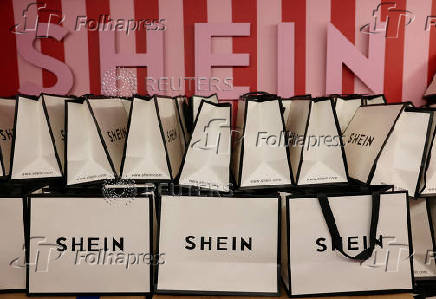 FILE PHOTO: A company logo for fashion brand Shein is seen on a pile of gift bags on its Christmas bus as part of a nationwide promotional tour in Liverpool, Britain