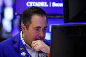Traders work on the floor at the New York Stock Exchange, in New York City