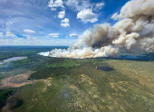 Smoke rises from wildfire SWF085 of the Red Earth East Complex, northwest of Fort McMurray
