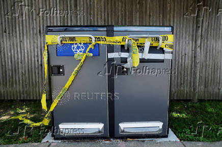 Caution tape seals off public trash bins in Waltham