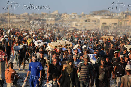 Palestinians carry aid supplies that entered Gaza through Israel, in Beit Lahia