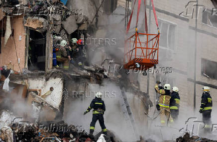 Aftermath of Dnipro apartment block destruction following missile strike