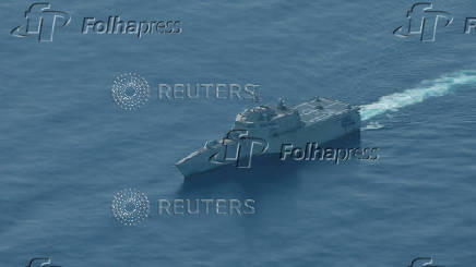An aerial view of the USS Cincinnati combat ship navigates near the disputed Scarborough Shoal, as a Philippine Coast Guard aircraft carrying journalists patrols the area