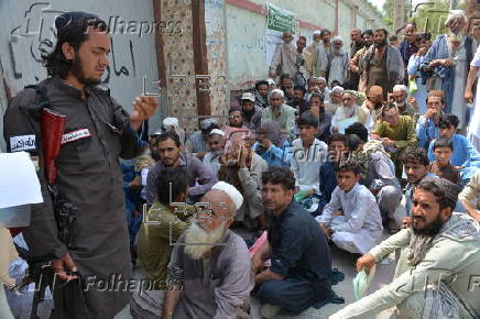 Afghan families, returned from neighboring Pakistan, receive food rations distributed by the Tawheed Charity Foundation in Jalalabad