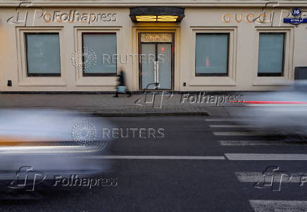 FILE PHOTO: Traffic moves past a closed Gucci store in Moscow