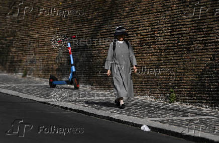 A nun walks near the Vatican after the election of Pope Leo XIV, in Rome