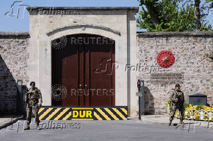 Military personnel stand guard outside the Turkish Presidency's Dolmabahce working office, in Istanbul