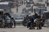 Displaced Palestinians flee their homes in the town of Beit Lahia, north of Gaza City,