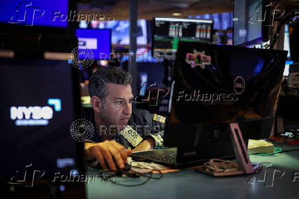 A trader works on the floor at the New York Stock Exchange (NYSE) in New York City