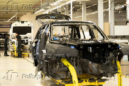 Technicians work on the assembly line for Rolls-Royce Cullinan and Ghost vehicles at Rolls-Royce Motor Cars' manufacturing plant in Goodwood