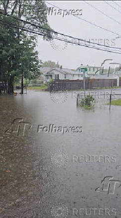 Rain falls on a flooded residential area, in  Weymouth
