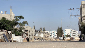 A girl runs from the scene as a missile lands during Israeli strikes on a school sheltering displaced people at the Bureij refugee camp in the central Gaza Strip