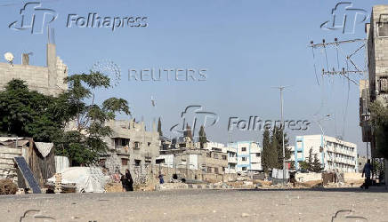 A girl runs from the scene as a missile lands during Israeli strikes on a school sheltering displaced people at the Bureij refugee camp in the central Gaza Strip