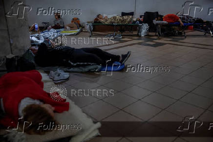 People take shelter inside a metro station during an air raid alert in Kyiv