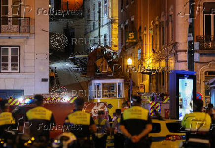 First responders work at the site of a funicular accident in Lisbon