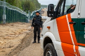 Finnish Border Guard at the barrier fence between Finland and Russia
