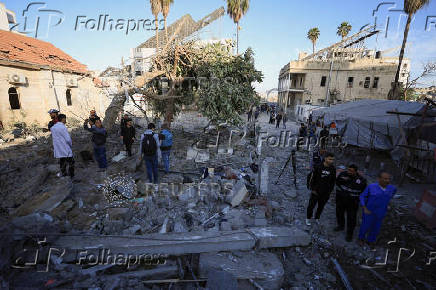 Palestinians inspect damage inside the Al-Ahli Arab Baptist Hospital in Gaza City