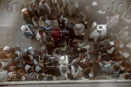 Afghans register for a labor program to work in Qatar