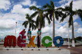 FILE PHOTO: Children sit on top a sign in Chetumal in the state of Quintana Roo, Mexico