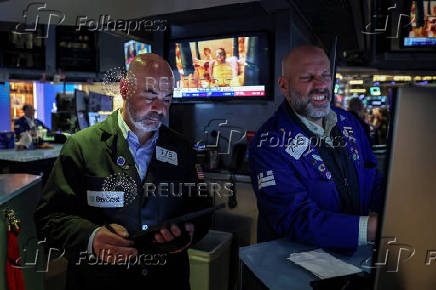Traders work on the floor at the New York Stock Exchange (NYSE) in New York City