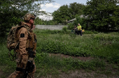 Residents pull bicycles as they walk in the frontline town of Kostyantynivka