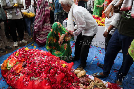 A family member mourns near the coffin of Chetnaba Chavda in Ahmedabad