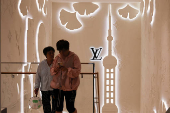 People walk in front of the new Louis Vuitton store in Shanghai