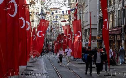 FILE PHOTO: People walk along Istiklal Avenue in Istanbul