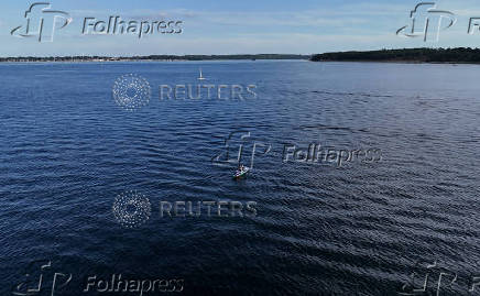 German stand-up paddler Michael Walther takes to the Baltic Sea for a test run in Kiel