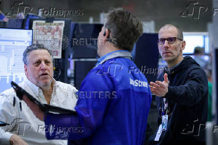 Traders work on the floor of the NYSE in New York