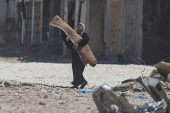 Palestinians carry their belongings after Israel's decision to demolish their homes in Nur Shams camp