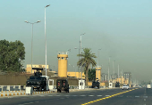 Armored vehicles belonging to Iraqi security forces are stationed outside the U.S. Embassy in Baghdad?s Green Zone,
