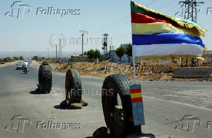 A druze flag flutters along a street, in Syria's predominantly Druze city of Sweida