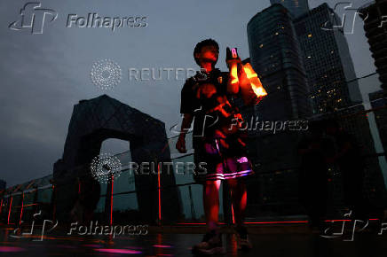 Person walks on a terrace of a shopping mall at the central business district (CBD), in Beijing