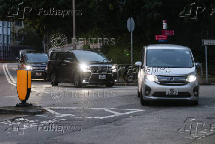 Vans believed to be carrying former Hong Kong lawmakers Kwok Ka-ki and Jeremy Tam leave from Stanley Prison, after serving four-year and two months sentences for conspiracy to commit subversion in a landmark national security case, in Hong Kong