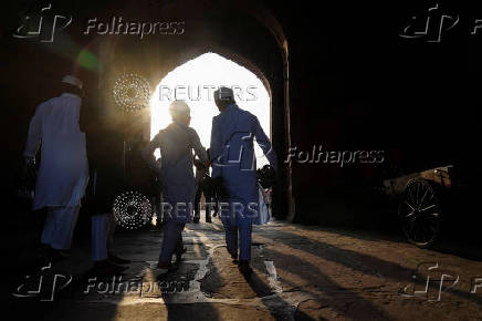Muslims leave after offering prayers at the Jama Masjid on the occasion of Eid al-Adha, in the old quarters of Delhi