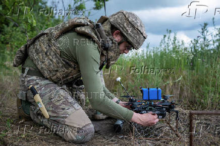 Ukrainian service member prepare an FPV-drones for a fly at a position near the front line town of Kupiansk